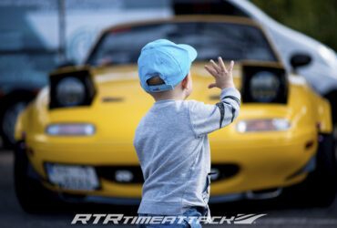 ребенок на фоне гоночной машины